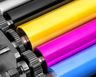 An image of four cylinders, coloured black, yellow, magenta, and cyan.