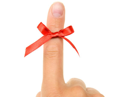 Image of a ribbon tied in a bow around a finger.